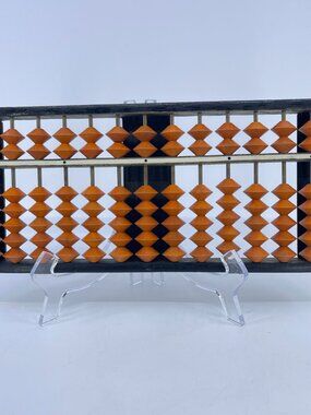 vintage japanese soroban abacus with a dark wooden frame and orange beads